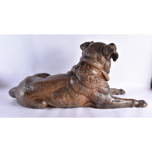 716 - A FINE AND RARE 19TH CENTURY AUSTRIAN COLD PAINTED TERRACOTTA DOG modelled recumbant with glass eyes... 