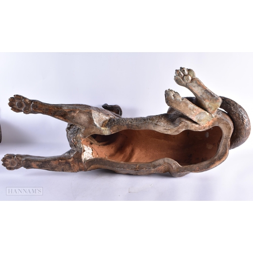 716 - A FINE AND RARE 19TH CENTURY AUSTRIAN COLD PAINTED TERRACOTTA DOG modelled recumbant with glass eyes... 