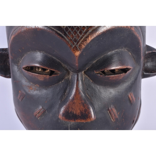 73 - AN AFRICAN TRIBAL CARVED WOOD MASK. 34 cm x 18 cm.