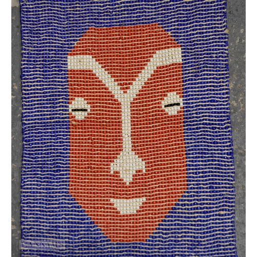 757 - A TRIBAL BEADWORK HANGING. 135 cm long.