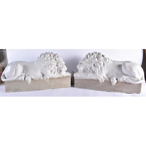 769 - A LARGE PAIR OF ITALIAN WHITE GLAZED CERAMIC LIONS. 55 cm wide.