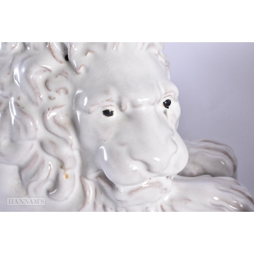 769 - A LARGE PAIR OF ITALIAN WHITE GLAZED CERAMIC LIONS. 55 cm wide.