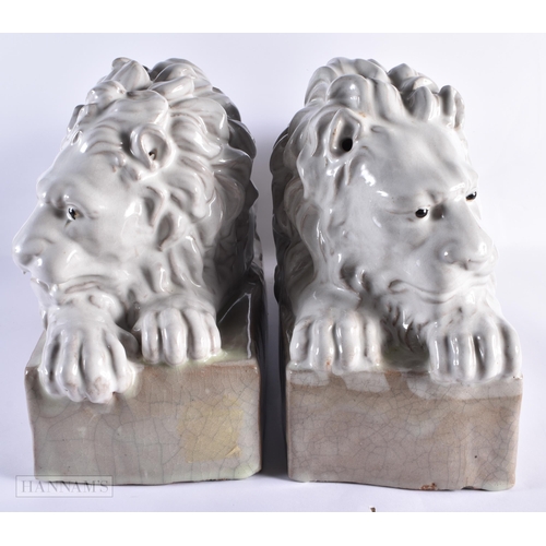 769 - A LARGE PAIR OF ITALIAN WHITE GLAZED CERAMIC LIONS. 55 cm wide.