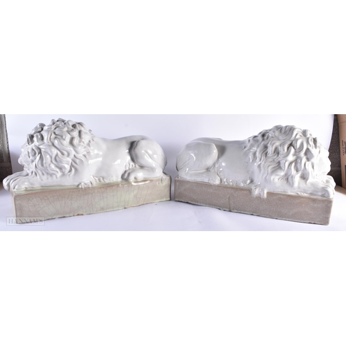 769 - A LARGE PAIR OF ITALIAN WHITE GLAZED CERAMIC LIONS. 55 cm wide.