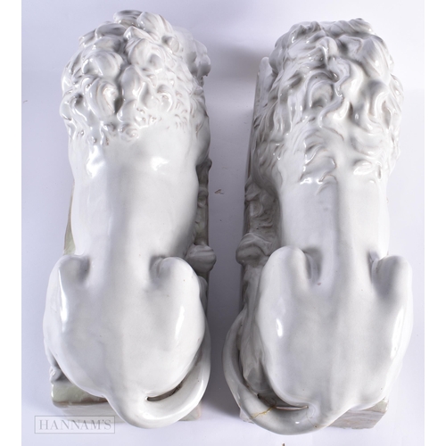 769 - A LARGE PAIR OF ITALIAN WHITE GLAZED CERAMIC LIONS. 55 cm wide.