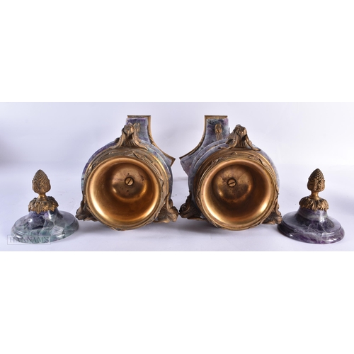 798 - A LARGE PAIR OF LATE 19TH CENTURY FRENCH MOUNTED STONE URNS AND COVERS possibly Bluejohn. 47 cm high... 