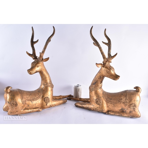 799 - A LARGE PAIR OF 18TH/19TH CENTURY INDIAN LACQUERED BRONZE DEER decorated with motifs. 54 cm x 50 cm.