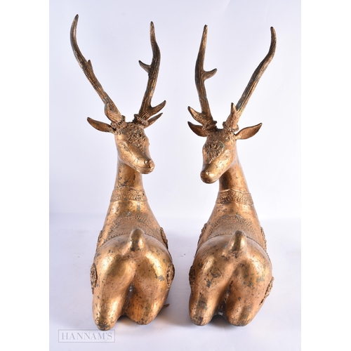 799 - A LARGE PAIR OF 18TH/19TH CENTURY INDIAN LACQUERED BRONZE DEER decorated with motifs. 54 cm x 50 cm.