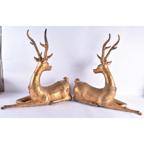 799 - A LARGE PAIR OF 18TH/19TH CENTURY INDIAN LACQUERED BRONZE DEER decorated with motifs. 54 cm x 50 cm.