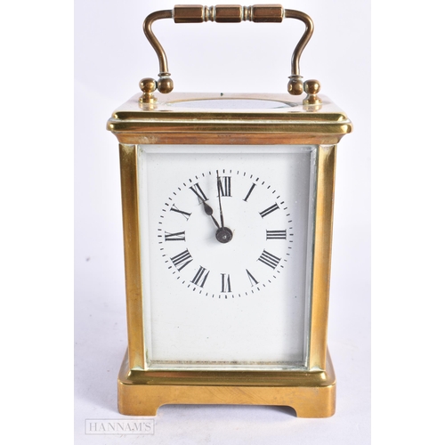 820 - A FRENCH CARRIAGE CLOCK together with a field microscope. Largest 18 cm long. (2)