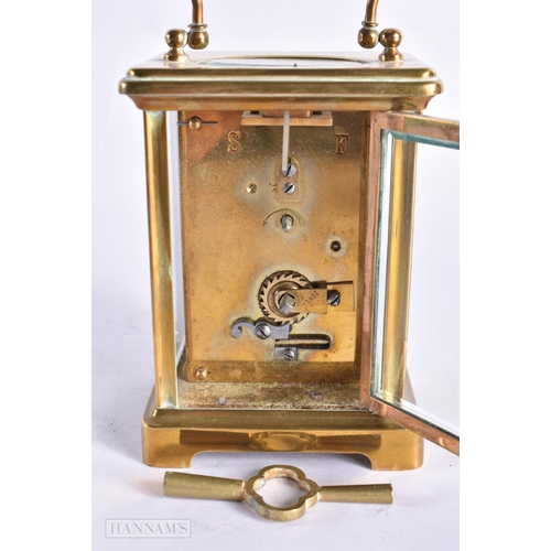 820 - A FRENCH CARRIAGE CLOCK together with a field microscope. Largest 18 cm long. (2)