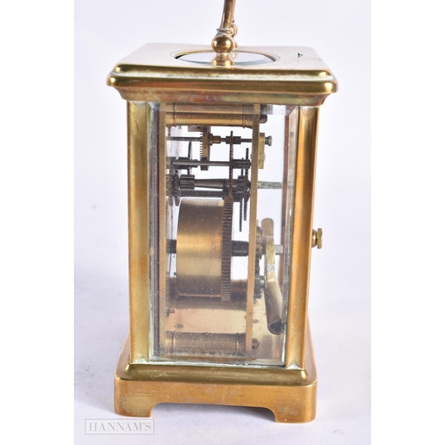 820 - A FRENCH CARRIAGE CLOCK together with a field microscope. Largest 18 cm long. (2)