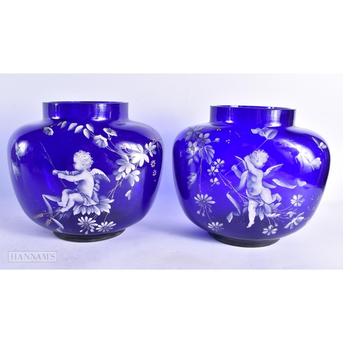 821 - A PAIR OF 19TH CENTURY FRENCH PATE SUR PATE BLUE GLASS VASES painted with putti in landscapes. 18 cm... 