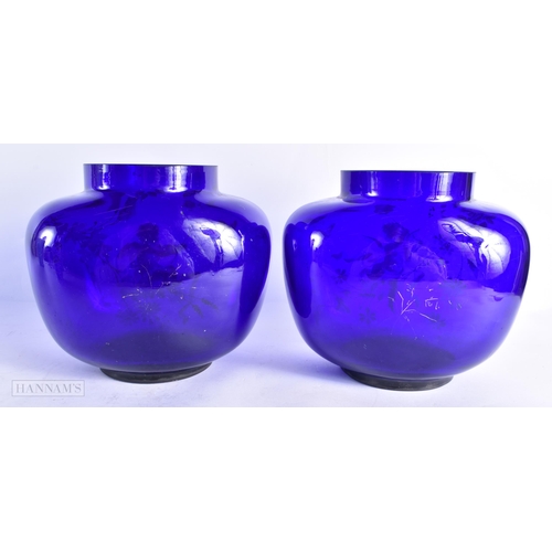 821 - A PAIR OF 19TH CENTURY FRENCH PATE SUR PATE BLUE GLASS VASES painted with putti in landscapes. 18 cm... 