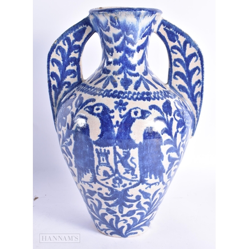 822 - AN ANTIQUE SPANISH TWIN HANDLED POTTERY ALHAMBRA VASE. 27 cm high.