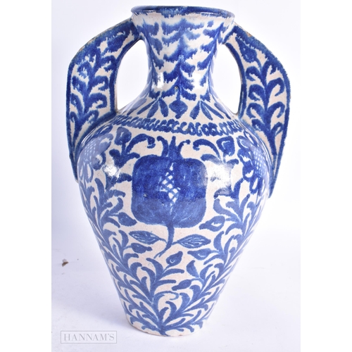 822 - AN ANTIQUE SPANISH TWIN HANDLED POTTERY ALHAMBRA VASE. 27 cm high.