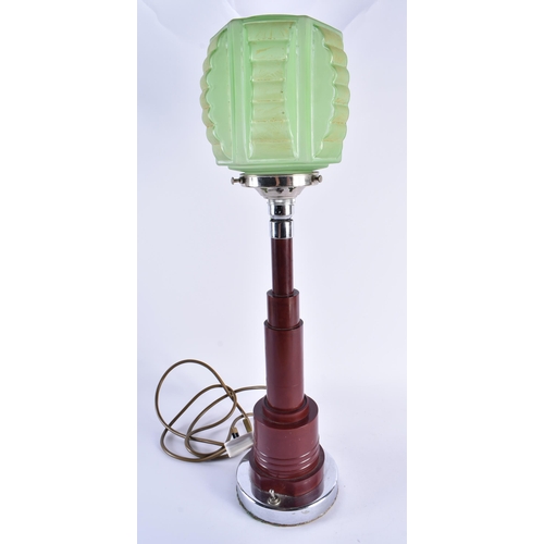 84 - A RARE ART DECO CHERRY BAKELITE LAMP with green glass shade. 55 cm high.