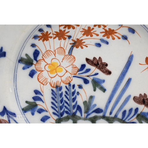 866 - Mid 18th century Lambeth polychrome plate painted with a large flower, smaller flowers, leaves and h... 