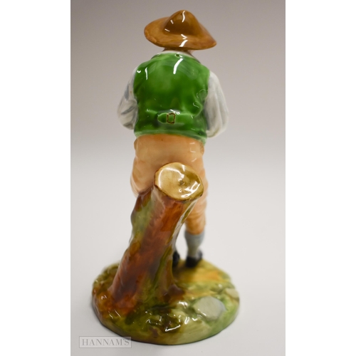 875 - Royal Worcester figure of a boy playing a pipe seated on a tree stump, painted in bright colours, ti... 