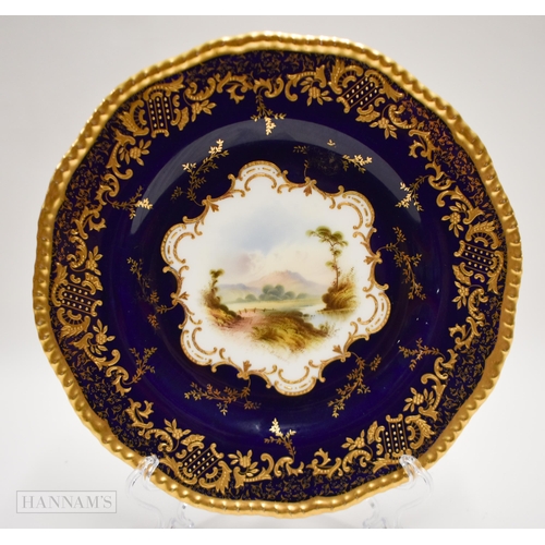 876 - Coalport plate with gilding on a cobalt blue ground, painted by P. Simpson, signed, with a scene nr.... 