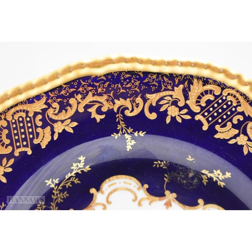 876 - Coalport plate with gilding on a cobalt blue ground, painted by P. Simpson, signed, with a scene nr.... 