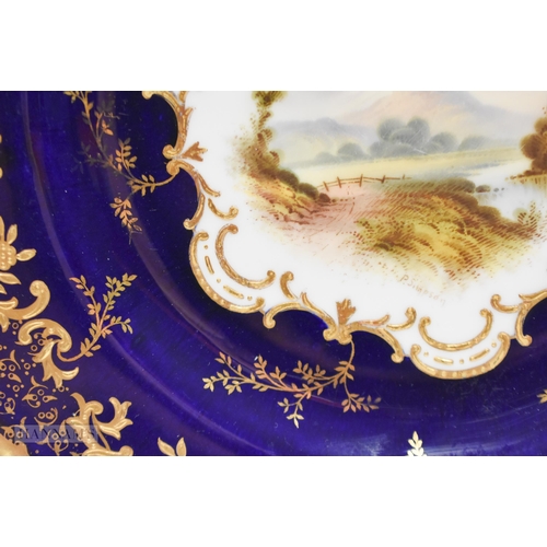 876 - Coalport plate with gilding on a cobalt blue ground, painted by P. Simpson, signed, with a scene nr.... 