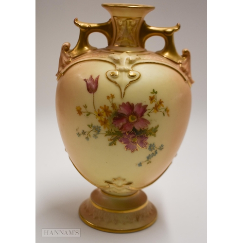 884 - Royal Worcester blush ivory vase on a circular base with twin gilt painted handles, decorated with f... 