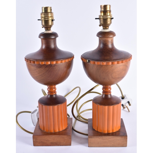 93 - A PAIR OF ART DECO CARVED WOOD AND ORANGE BAKELITE LAMPS. 35 cm high.