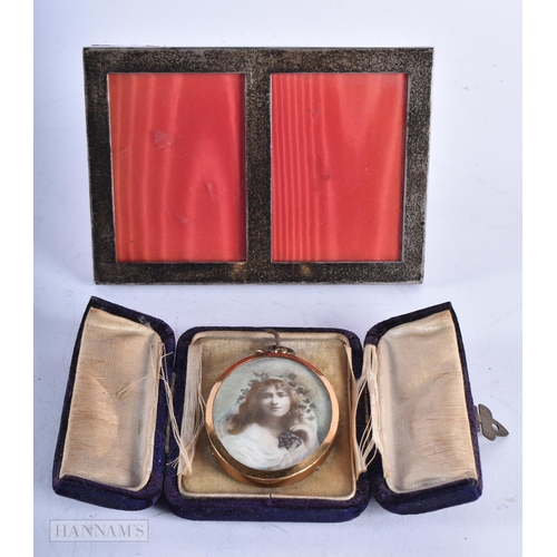 1794 - A SILVER FRAME and a yellow metal locket. (2)