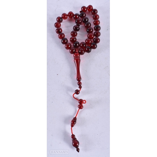 1954 - A CHERRY AMBER TYPE NECKLACE. 22 grams. 60 cm long overall, largest bead 5 cm long.