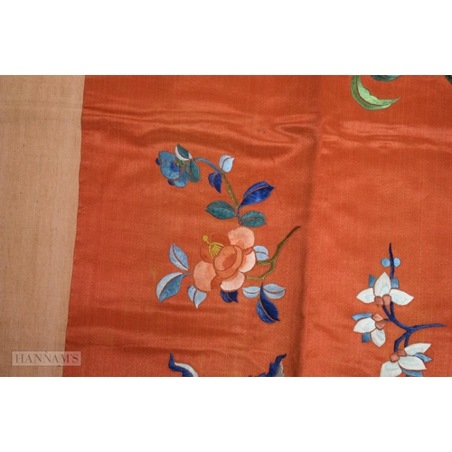 2868 - A LONG 19TH CENTURY CHINESE ORANGE RED SILK EMBROIDERED PANEL decorated with flowers. 190 cm x 57 cm