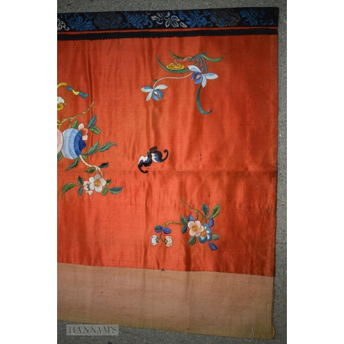 2868 - A LONG 19TH CENTURY CHINESE ORANGE RED SILK EMBROIDERED PANEL decorated with flowers. 190 cm x 57 cm