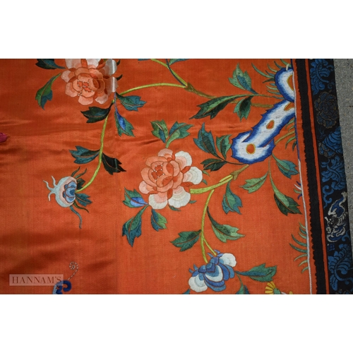 2868 - A LONG 19TH CENTURY CHINESE ORANGE RED SILK EMBROIDERED PANEL decorated with flowers. 190 cm x 57 cm