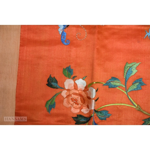 2868 - A LONG 19TH CENTURY CHINESE ORANGE RED SILK EMBROIDERED PANEL decorated with flowers. 190 cm x 57 cm