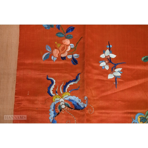 2868 - A LONG 19TH CENTURY CHINESE ORANGE RED SILK EMBROIDERED PANEL decorated with flowers. 190 cm x 57 cm