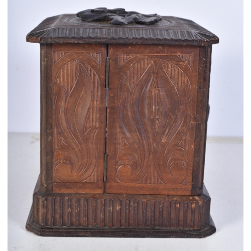 3052 - A carved Black Forest smokers compendium 18.5 x 17 x 22 cm.