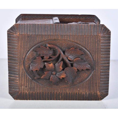 3052 - A carved Black Forest smokers compendium 18.5 x 17 x 22 cm.