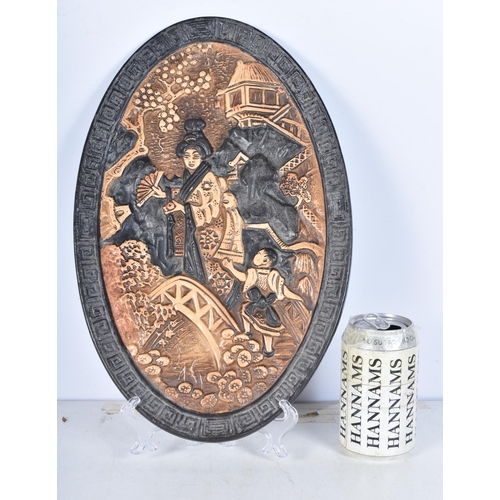 3085 - A c1920 Bretby pottery Oval wall plaque , relief moulded Oriental scene 38 x 24cm.