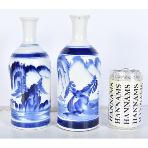 3086 - A pair of Korean blue and white vases decorated with a mountainous landscape 22cm (2).