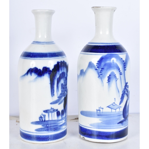 3086 - A pair of Korean blue and white vases decorated with a mountainous landscape 22cm (2).