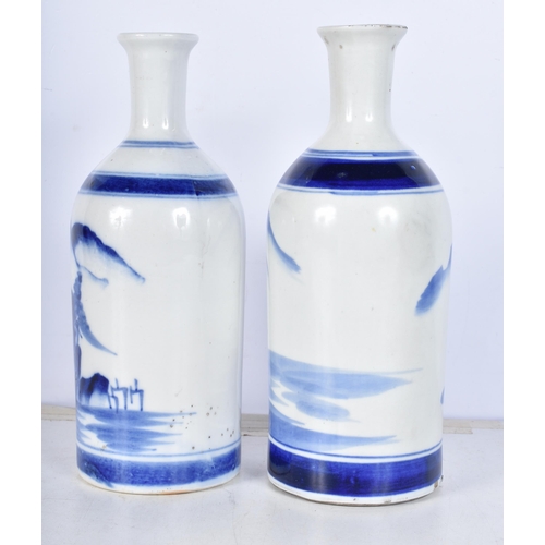 3086 - A pair of Korean blue and white vases decorated with a mountainous landscape 22cm (2).