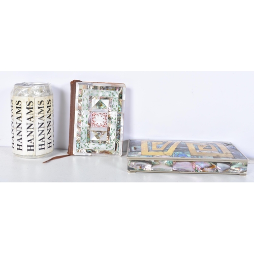 3102 - A Mexican silver abalone covered box with a brass insert to the lid together with a copy of the New ... 