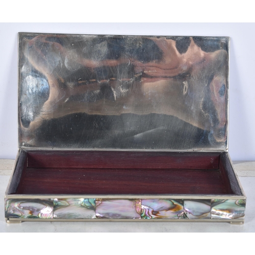 3102 - A Mexican silver abalone covered box with a brass insert to the lid together with a copy of the New ... 