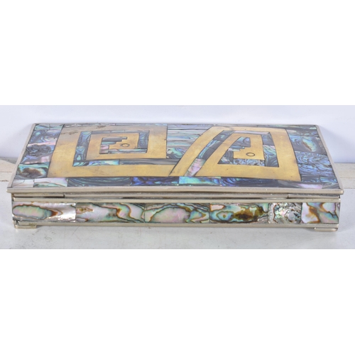 3102 - A Mexican silver abalone covered box with a brass insert to the lid together with a copy of the New ... 