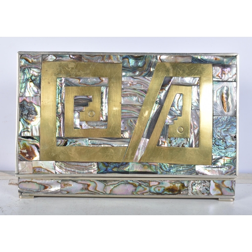 3102 - A Mexican silver abalone covered box with a brass insert to the lid together with a copy of the New ... 