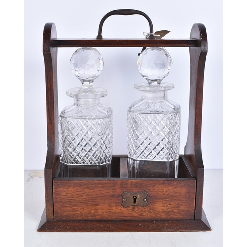 3242 - A vintage 2 crystal decanter Tantalus 29 x 24cm (2).