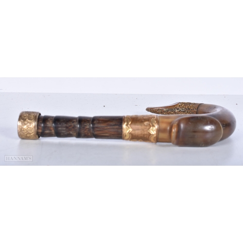 3641 - A Rhino horn handled cane handle with gilt metal collars and decoration 17cm.