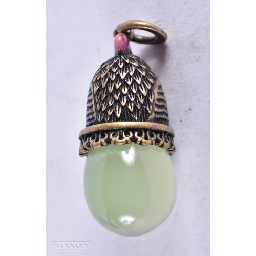 3911 - A Continental Silver Gilt and Jade Chick and Egg Pendant. Stamped 84. 3.2cm x 1.2cm, weight 8.4g