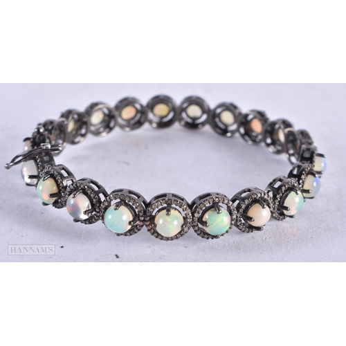 3916 - An Opal and Diamond Bangle. Internal diameter 5.9cn, weight 23.7g