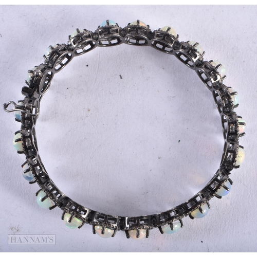 3916 - An Opal and Diamond Bangle. Internal diameter 5.9cn, weight 23.7g